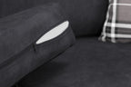 Close-up of a black sofa cushion with visible zipper and inner filling