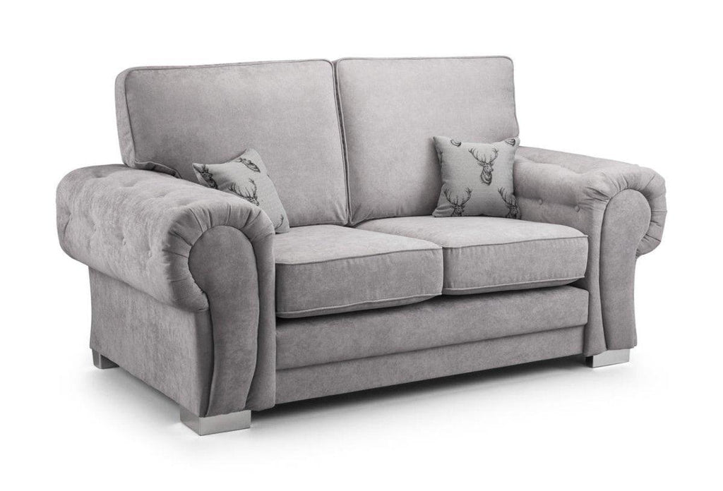 Light grey 2 seater sofa with plush cushions and two decorative stag pillows on white background