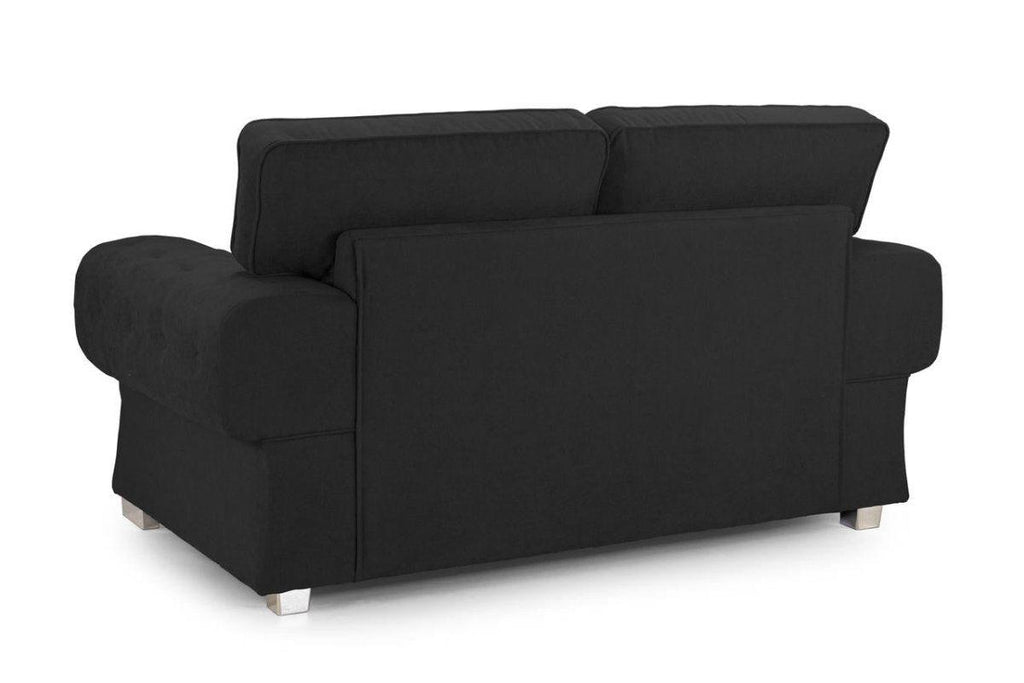 Back view of modern black 2-seater sofa with plush cushioning and short metallic legs