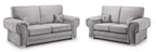 Modern grey velvet 3 and 2 seater sofa set with rolled arms and patterned accent pillows