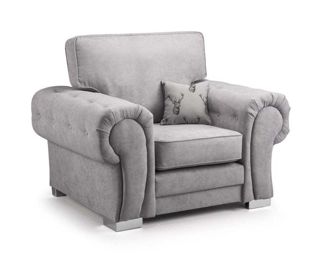Plush grey velvet armchair with rolled arms and patterned accent cushion, modern style.