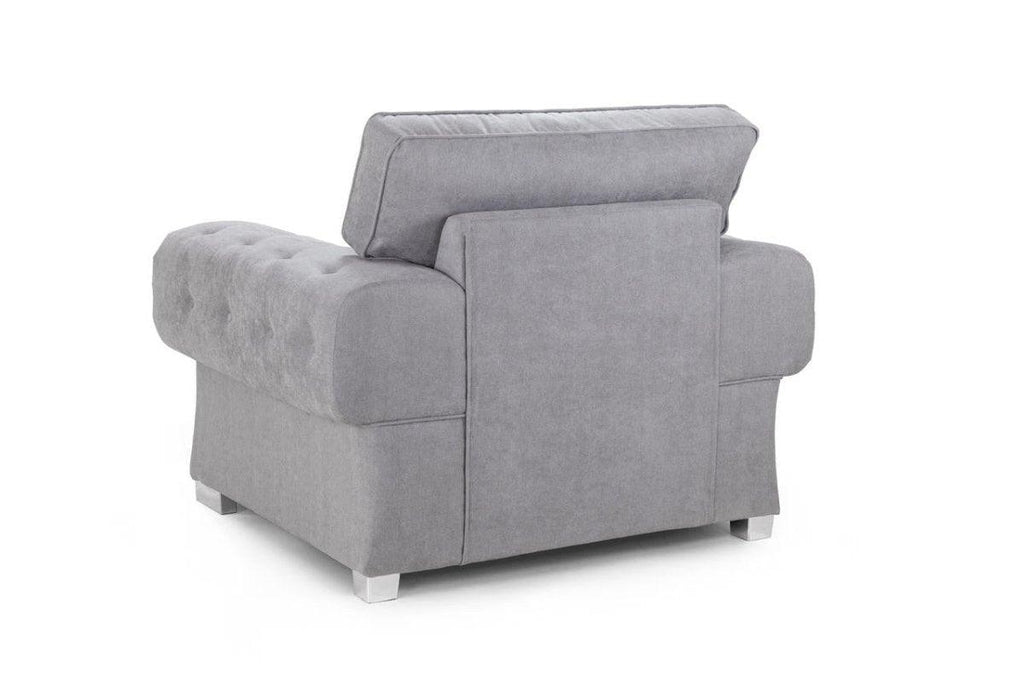 Modern grey fullback armchair with tufted upholstery and metal legs, rear view