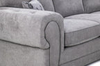 Close-up of a grey fabric sofa armchair with plush cushions and a decorative pillow