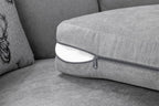 Removable grey sofa cushion with visible zipper, close-up on modern fabric armchair