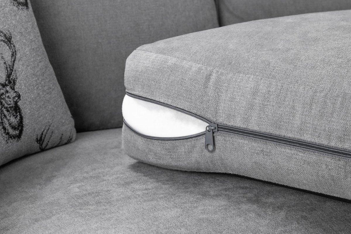 Removable grey sofa cushion with visible zipper, close-up on modern fabric armchair