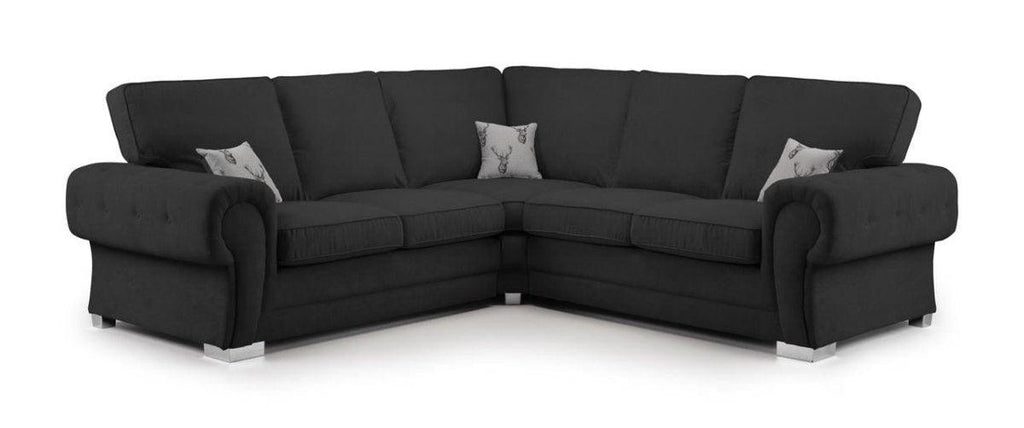 Black corner sofa with full back cushions and two printed accent pillows, modern style