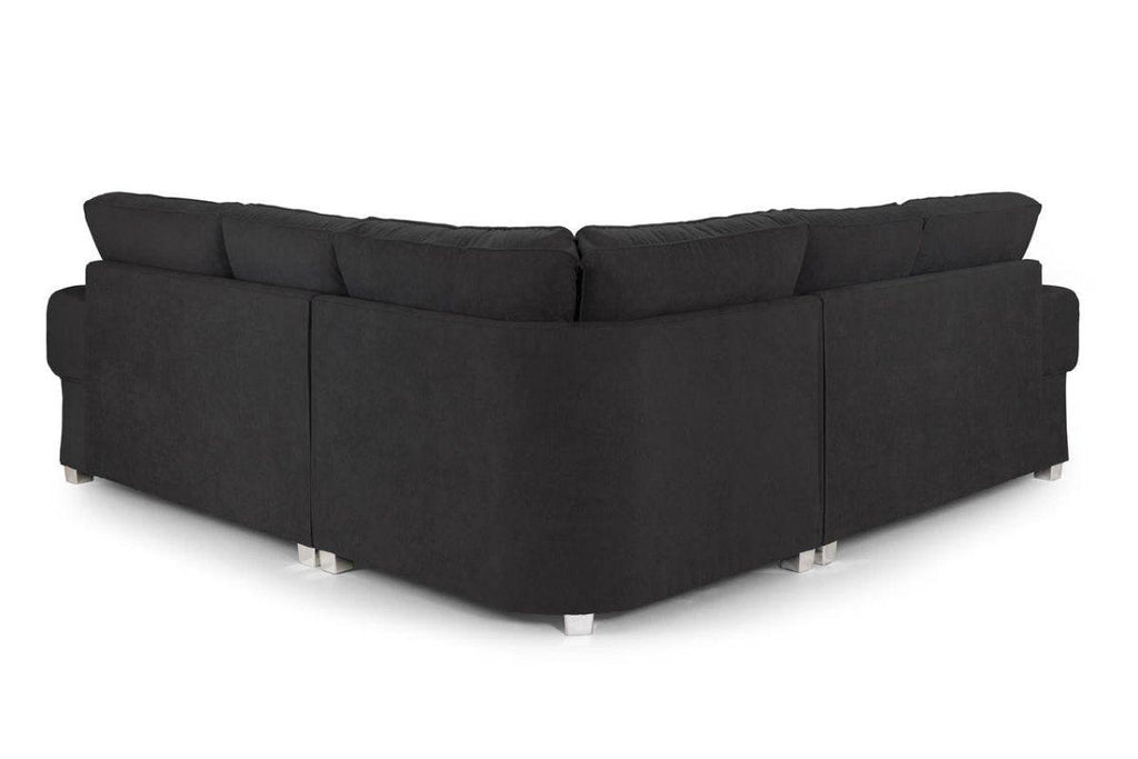 Modern black corner sofa with plush back cushions and metal legs, rear view on white background