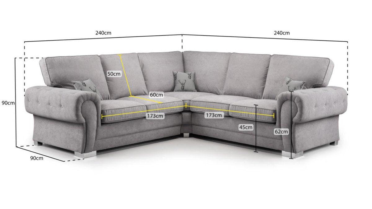Grey L-shaped corner sofa with detailed measurements, tufted arms, and decorative pillows