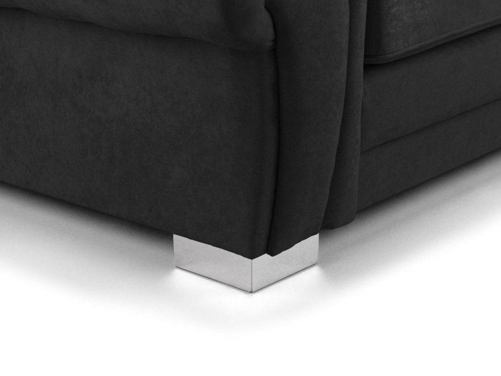 Close-up of black fabric corner sofa base with modern chrome metal feet on white floor