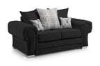 Black two-seater scatter back sofa with plaid and stag motif cushions on silver legs