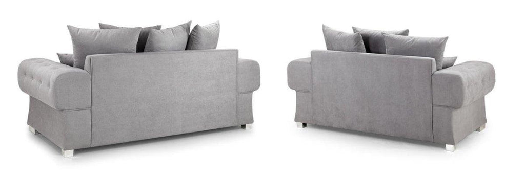 Set of two grey scatter back sofas with plush cushions on white background