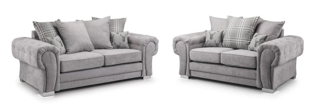Grey two and three seater sofa set with scatterback cushions and plaid pillow accents