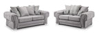 Grey two and three seater sofa set with scatterback cushions and plaid pillow accents
