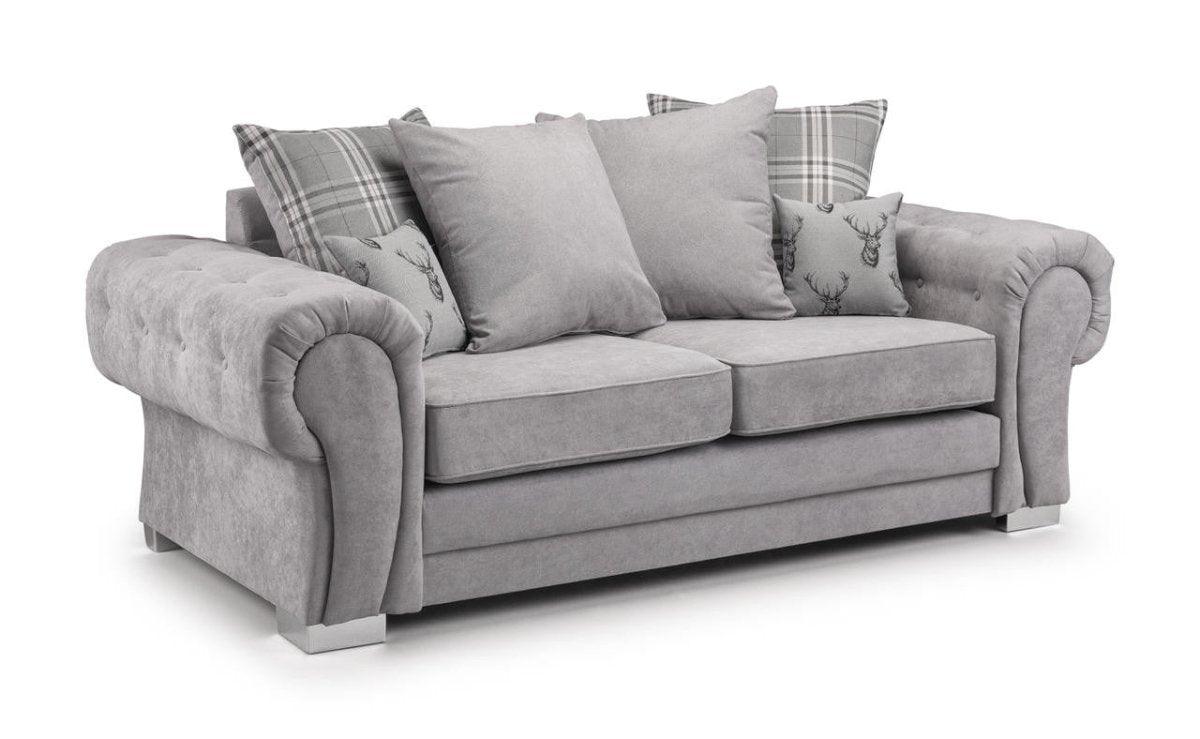 Grey velvet 3 seater sofa with scatterback cushions, plaid and stag print pillows