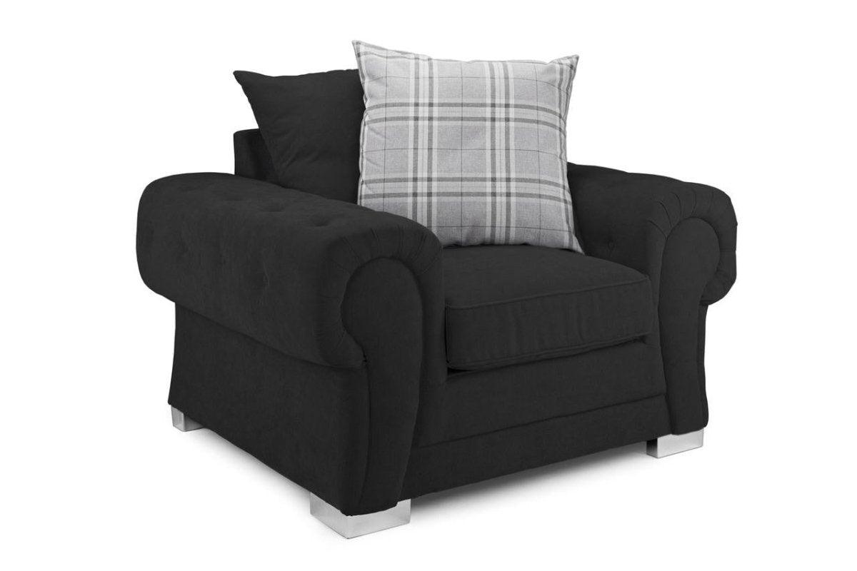 Black scatterback armchair with rolled arms, chrome legs, and a plaid cushion