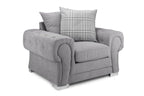 Grey velvet scatterback armchair with rolled arms and plaid cushion on white background