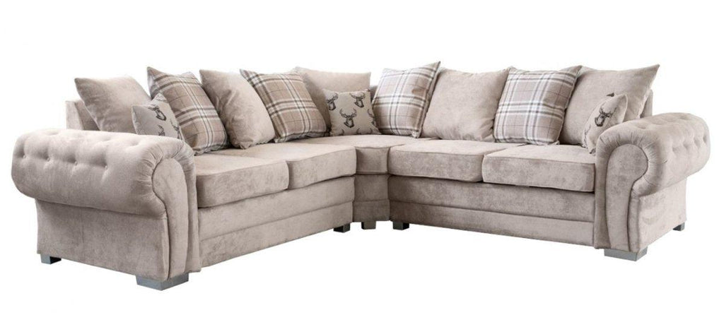 Beige velvet corner sofa with tufted arms and plaid scatter cushions