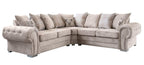 Beige velvet corner sofa with tufted arms and plaid scatter cushions