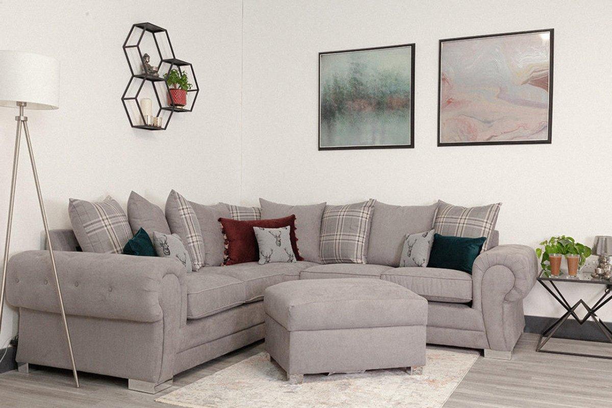 Grey scatter back corner sofa with matching ottoman in modern living room
