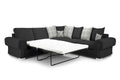 Black corner sofa bed with plaid and deer print scatter cushions, extended into a bed