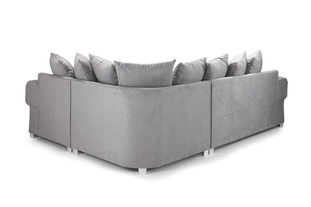 Light grey corner sofa with scatter back cushions and modern block feet on white background