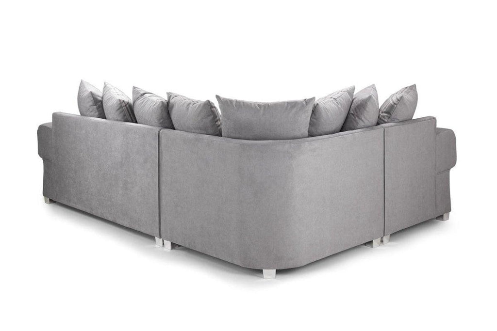 grey corner sofa with scatter back cushions and modern design on white background