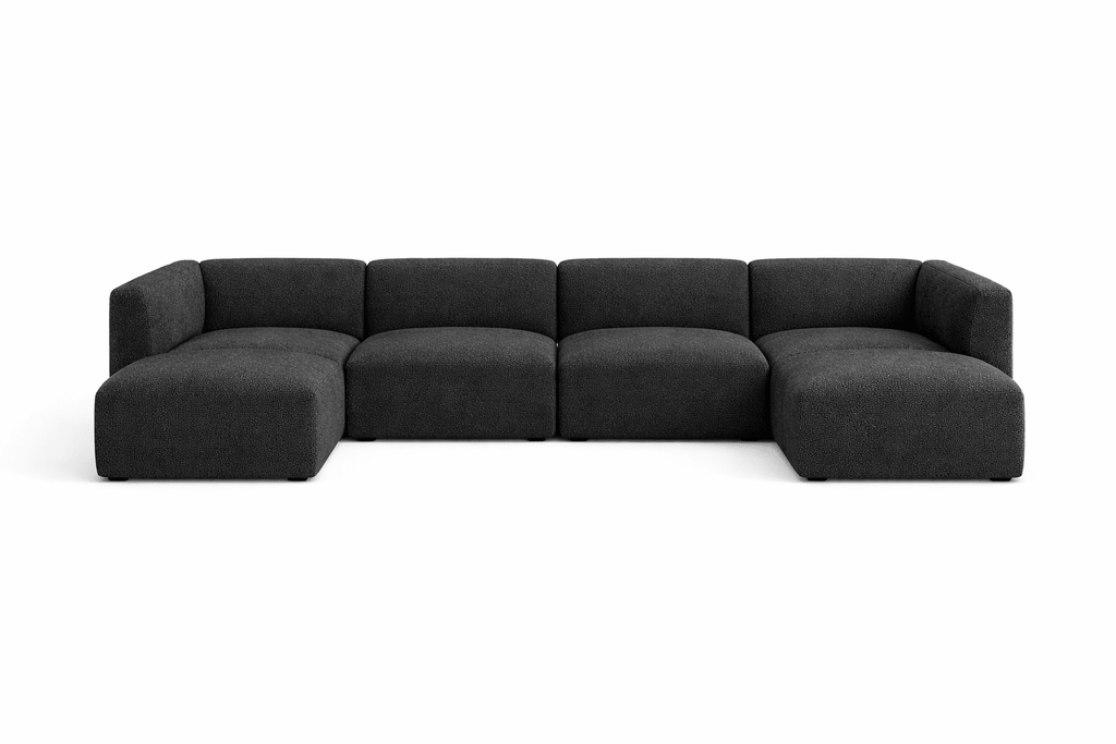 Modern dark grey U-shaped modular sofa with low back and plush seating, isolated on white