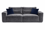 Modern grey velvet 4-seater sofa with wide arms and two navy blue throw pillows