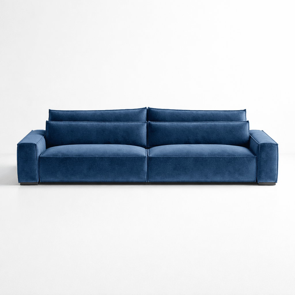 Modern blue velvet four-seater sofa with wide arms and deep cushions against a white background
