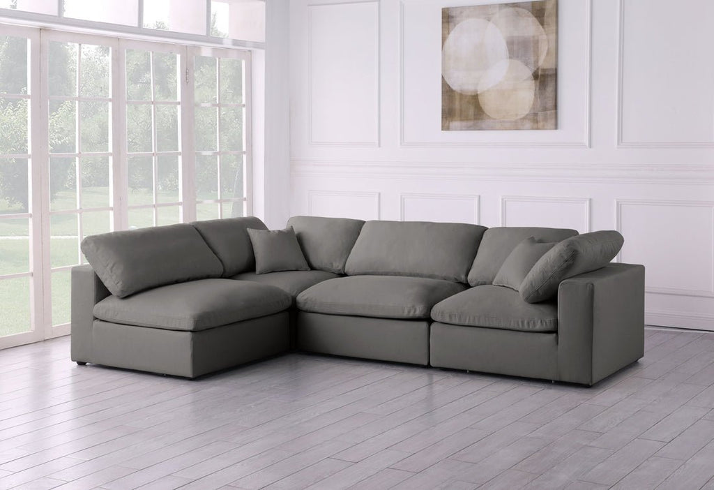 Cream feather-filled corner sofa with plush cushions in a modern, bright living room