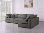 Modern cream corner sofa with feather-filled cushions in bright living room