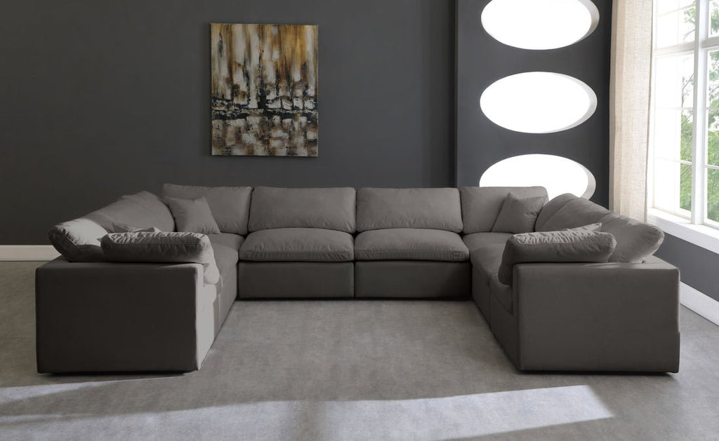 Cream U-shape sectional sofa with feather-filled cushions in a modern living room