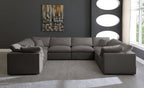 Cream U-shape sectional sofa with feather-filled cushions in a modern living room
