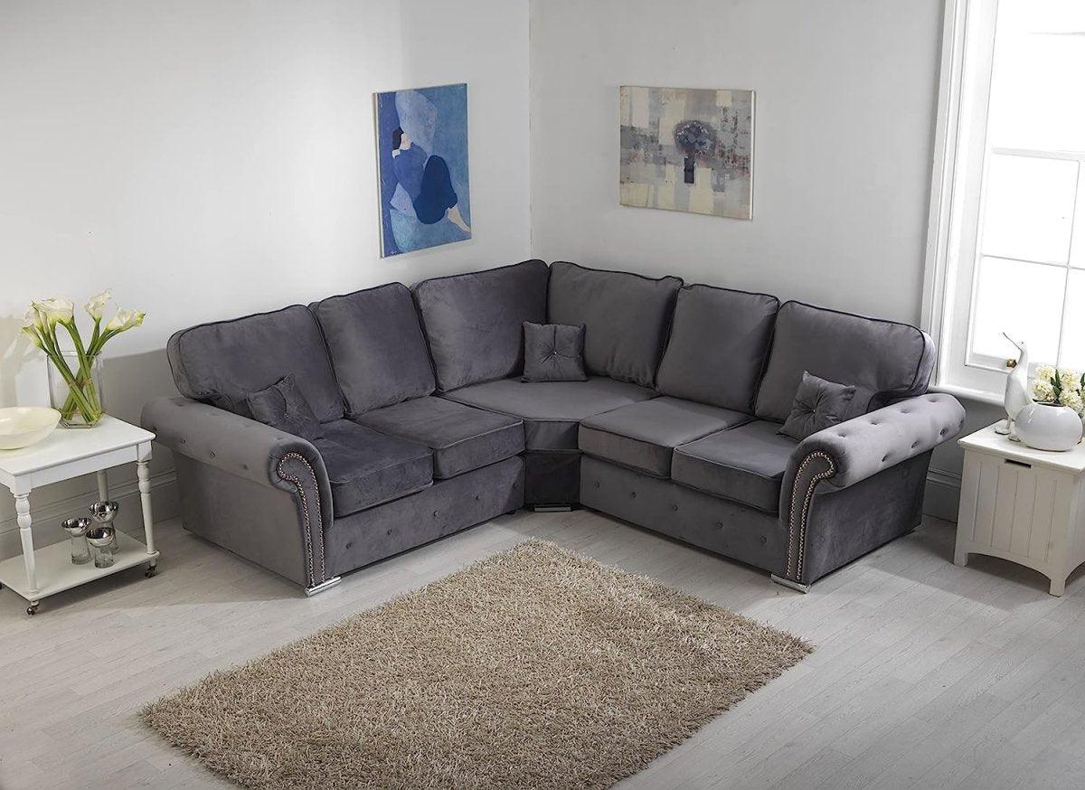 Grey corner sofa with full-back cushions in a modern living room, next to light wood decor