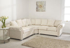 Cream corner sofa fullback with scatter cushions in bright modern living room