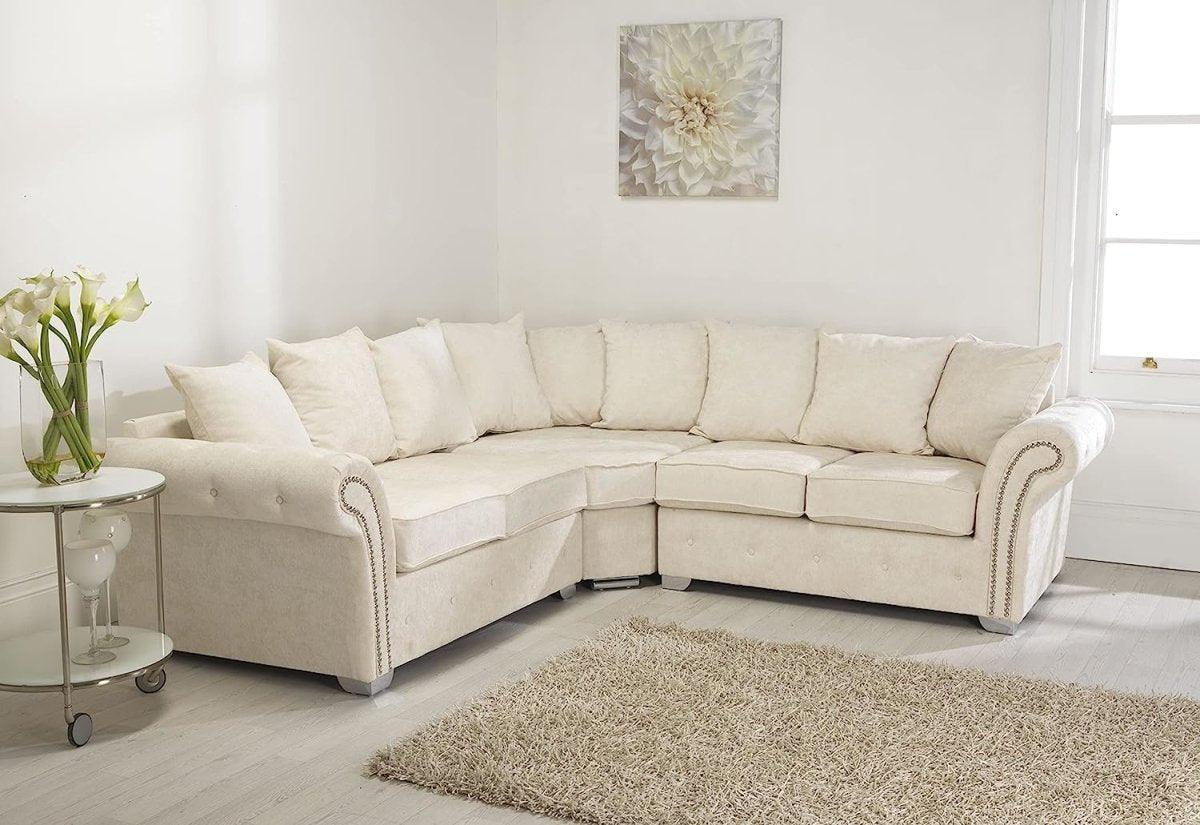 Cream corner sofa fullback with scatter cushions in bright modern living room