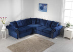 Navy blue corner sofa with plush scatterback cushions in a bright, modern living room