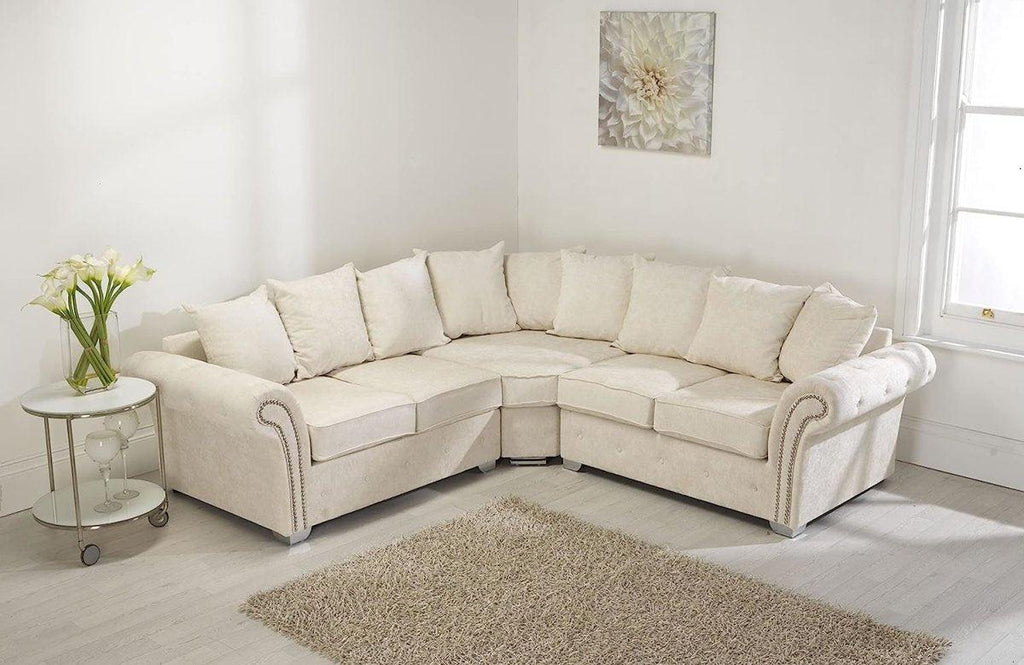 Cream corner sofa with scatter back cushions in a bright living room with light decor