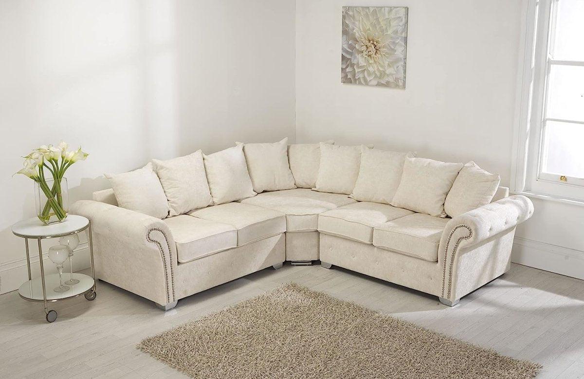 Cream corner sofa with scatter back cushions in a bright living room with light decor