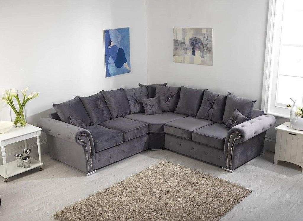 Grey corner sofa with scatterback cushions in a bright modern living room
