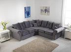 Grey corner sofa with scatterback cushions in a bright modern living room