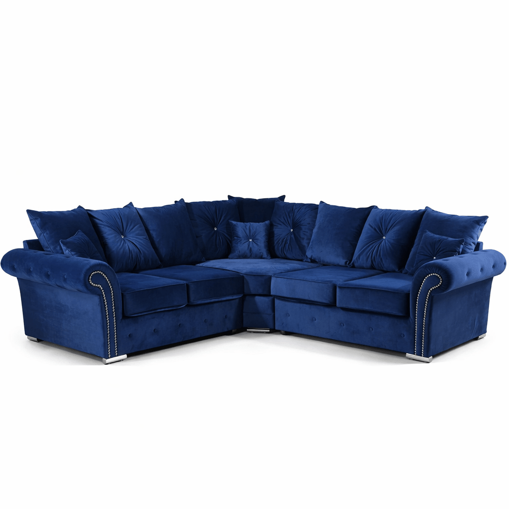 Blue velvet corner sofa with scatter back cushions and silver stud detailing