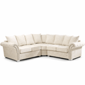 Cream corner sofa with scatter back cushions and studded arms on chrome legs