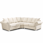 Cream corner sofa with scatter back cushions and studded arms on chrome legs