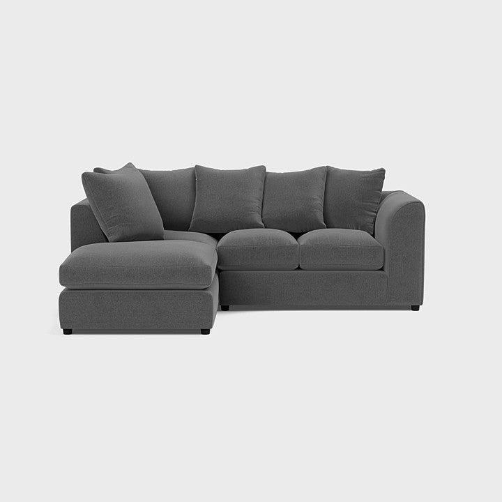 Modern grey corner sofa with plush cushions and left-hand chaise on a plain background