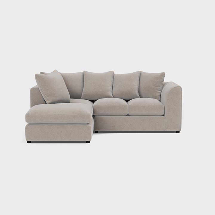 Cream fabric corner sofa with chaise, plush cushions, and modern minimalist design