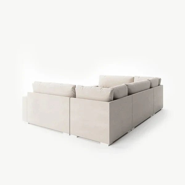 Cream U-shaped modular sofa with plush cushions on white background