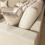 Cream U-shape sofa with plush fiber cushions and soft accent pillows in a living room