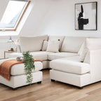 Plush cream U-shape sofa in modern loft living room with wood floors and neutral decor