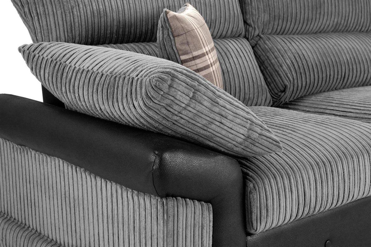 Grey corduroy two-seater sofa with black faux leather armrest and plaid accent cushion